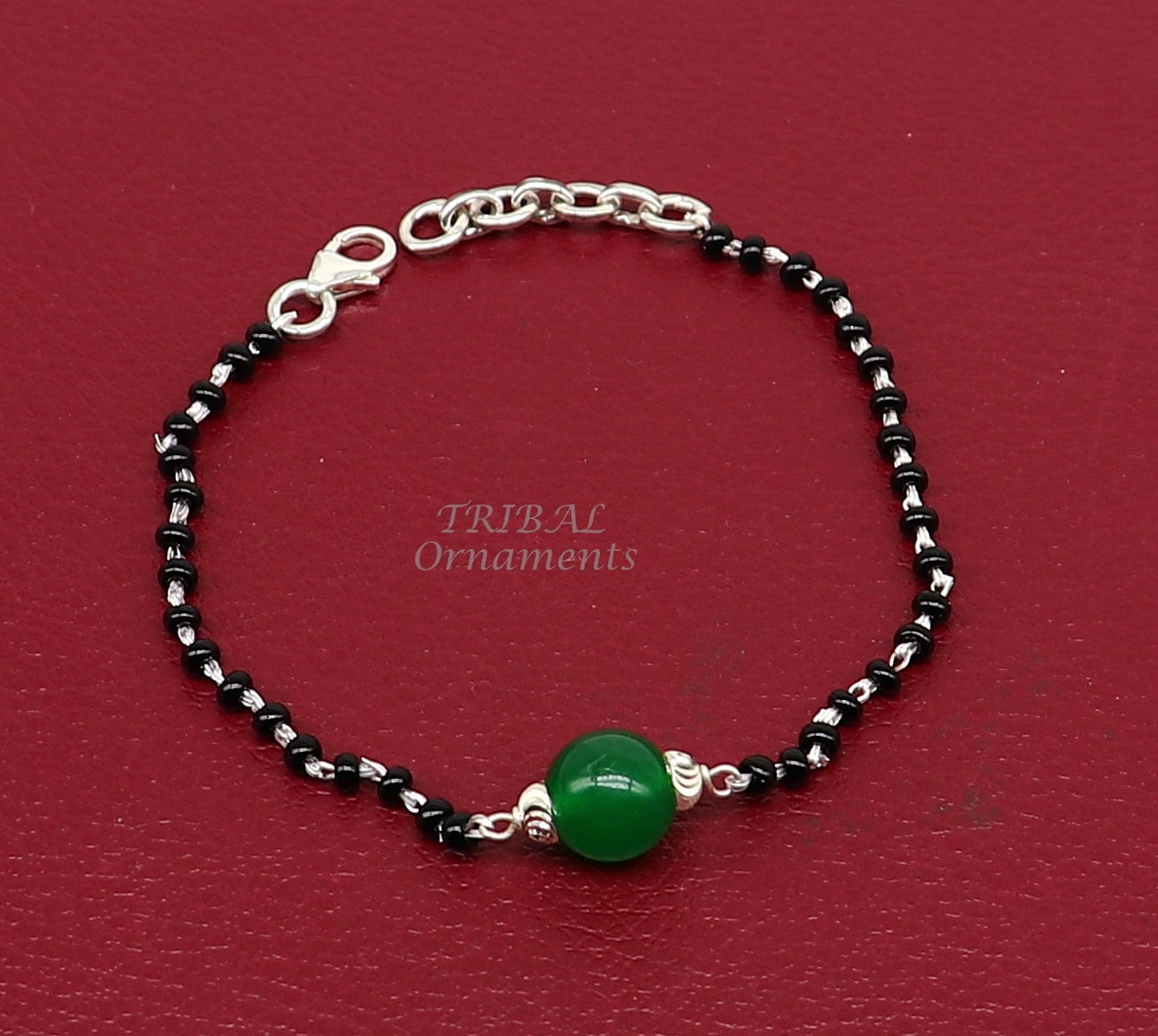 green and black rubber band bracelet — Weasyl